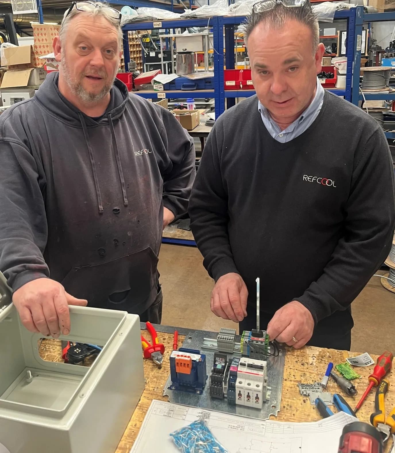 Refcool technicians preparing control systems for installation