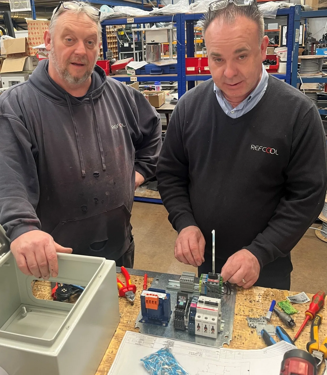 Refcool technicians preparing control systems for installation